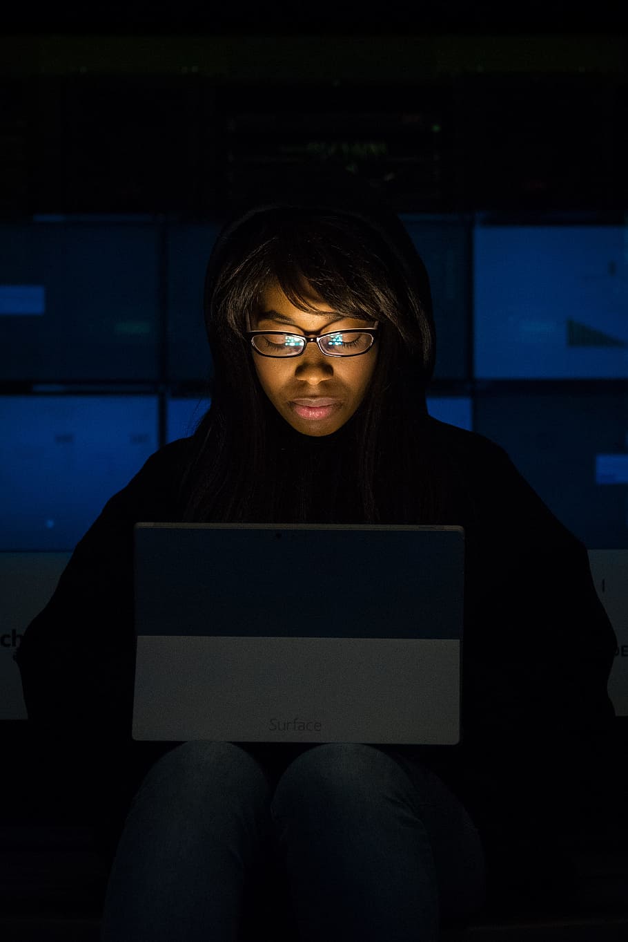 Woman Wearing Eyeglasses Looking at Tablet Computer in Dark Room HD wallpaper
