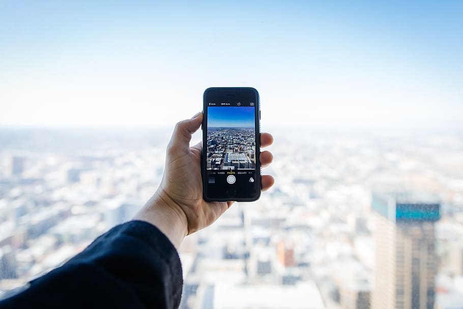 Person Holding Smartphone, apple, buildings, camera, city, citylife HD wallpaper