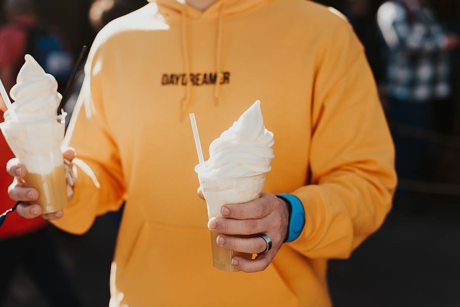 person holding soft ice cream, food, creme, dessert, apparel