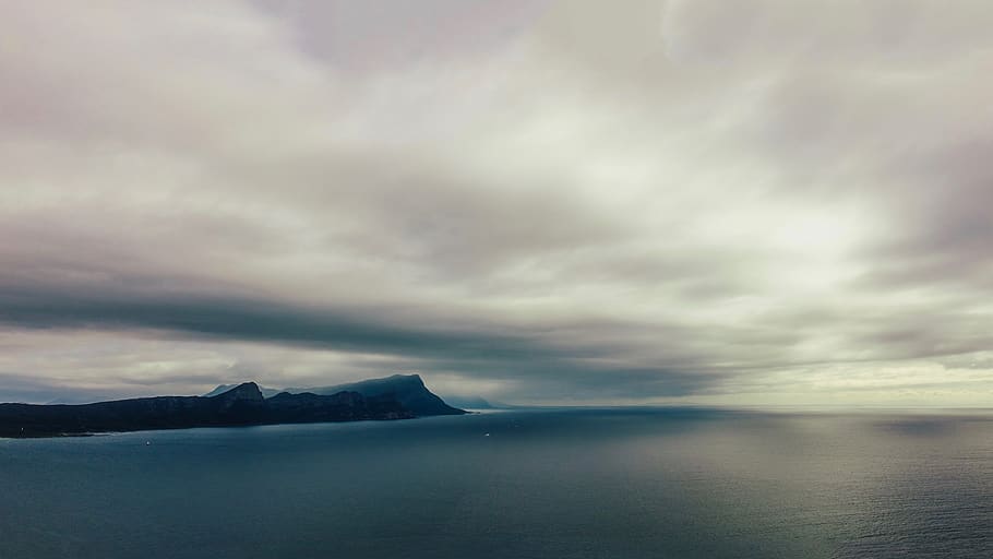 cloudy sky over hill in beach, sea, ocean, nature, land, outdoors HD wallpaper