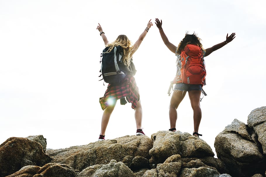 Two Women in Hiking Backpacks Standing on Gray Stones, backpacker HD wallpaper