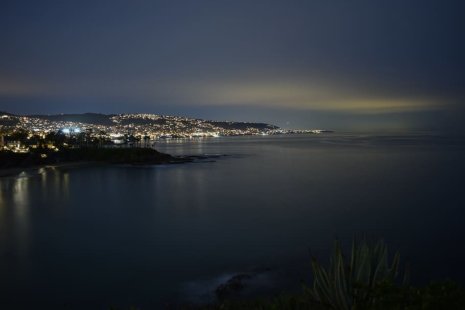 city lights near calm sea during nighttime, land, nature, outdoors, HD wallpaper