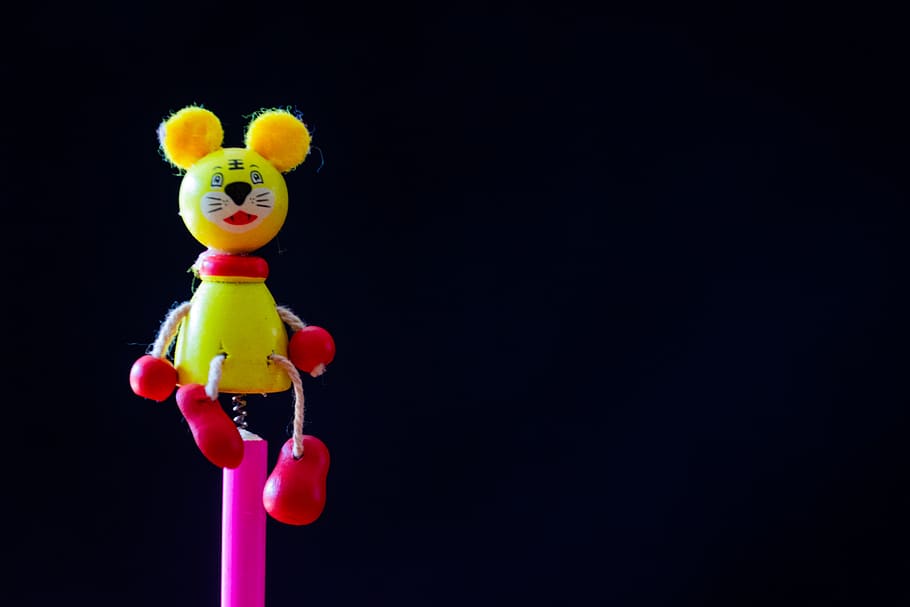 Close-up Photo of Yellow and Red Mouse Character Toy, black background HD wallpaper