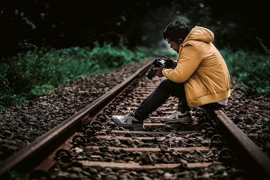 train track, traveller, yellow, jacket, yellow jacket, camera HD wallpaper