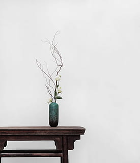 white flowers with green ceramic vase on top of brown wooden side table HD wallpaper