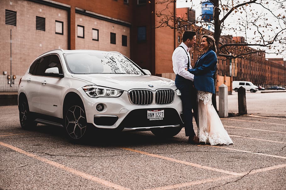 man and woman standing beside BMW SUV, car, motor vehicle, mode of transportation, HD wallpaper