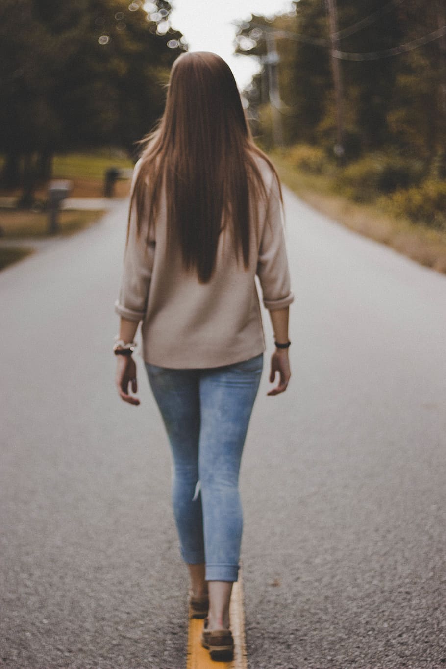 woman in grey shirt and blue denim pants walking on road during daytime, HD wallpaper