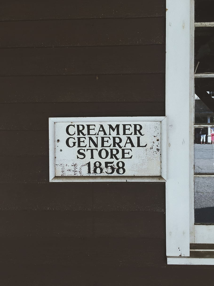 1858 Creamer General Store signage on wooden wall, label, text