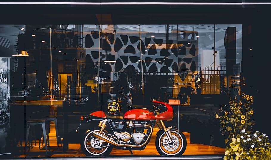 Red Standard Motorcycle With Gold Helmet Near Glass Wall, daytime HD wallpaper