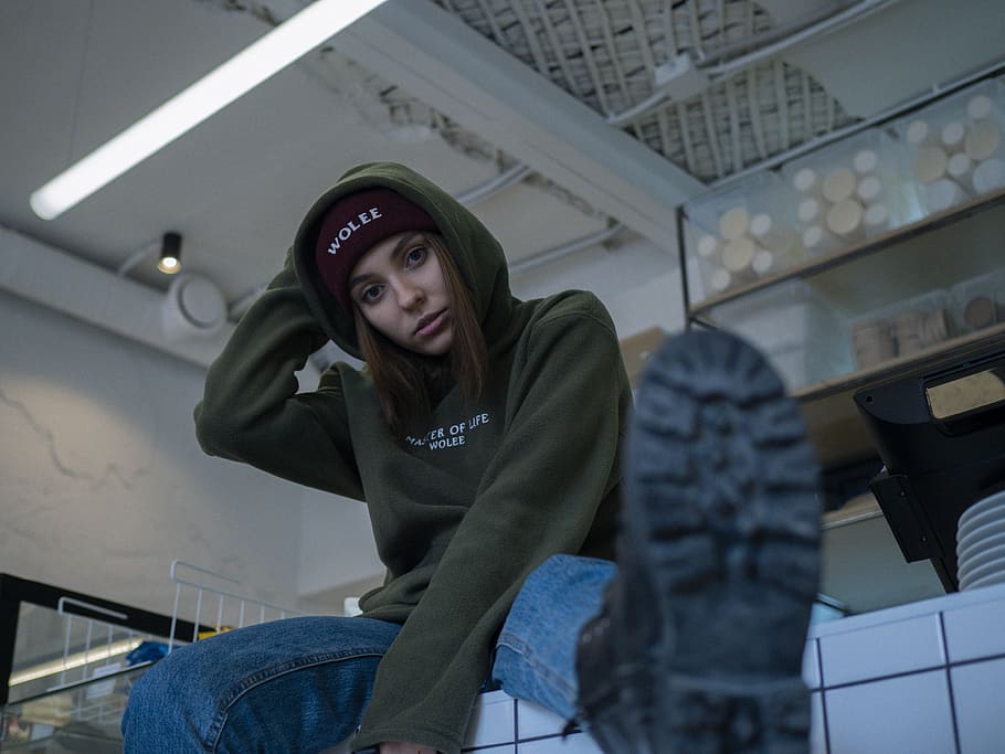 woman-wearing-green-pullover-hoodie-and-blue-jeans.jpg