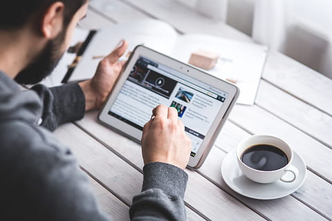 Man using stylus pen for touching the digital tablet screen, browser HD wallpaper