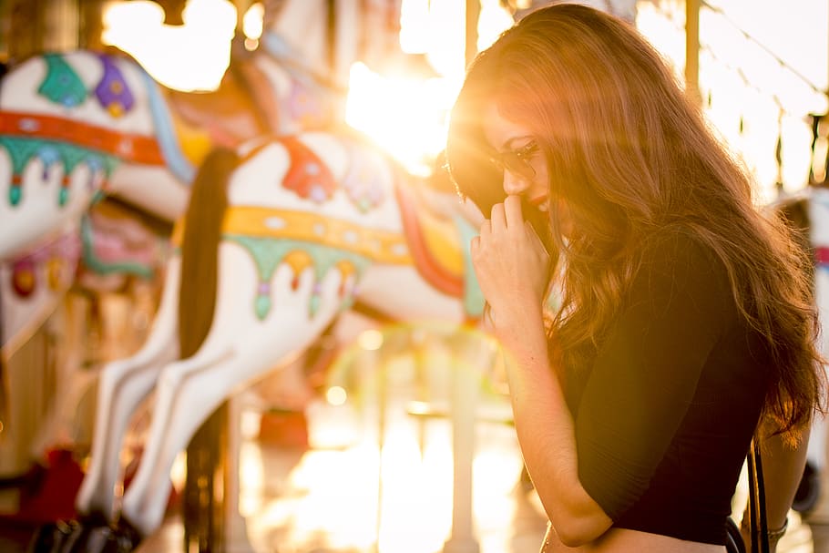 Woman Standing in Front of Carousel, emotions, fun, fun fair HD wallpaper