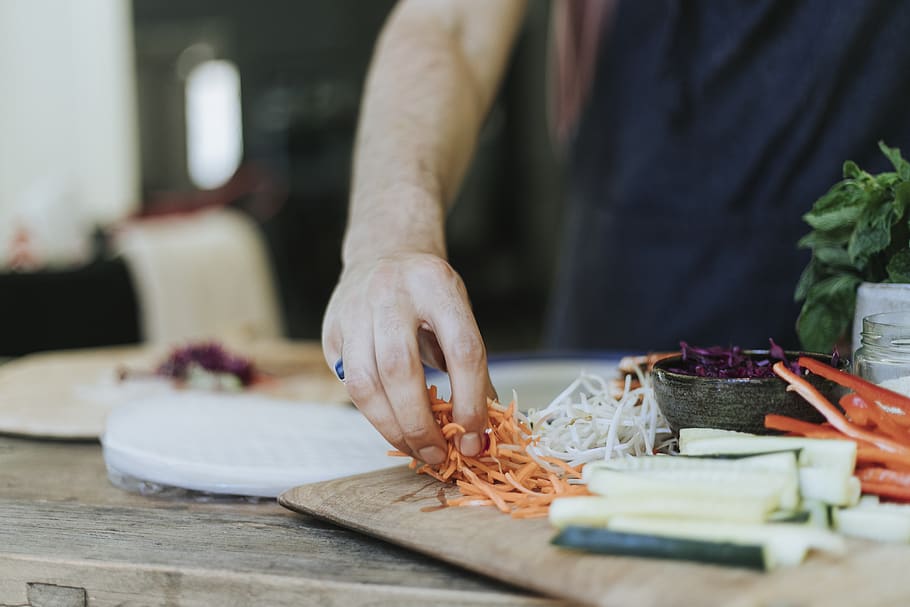 Person Holding Sliced of Carrots, adding, blurred background HD wallpaper