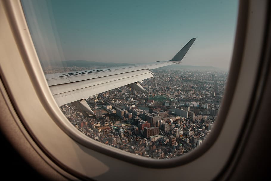 white airplane wing, air vehicle, window, flying, city, transportation