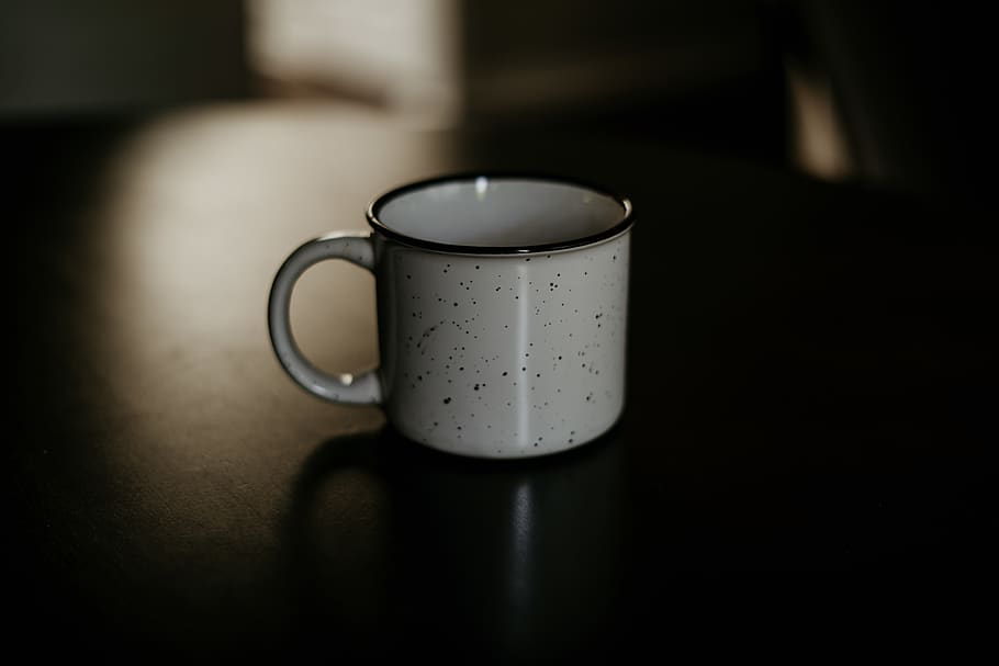white and black ceramic cup on black surface, mug, coffee cup HD wallpaper