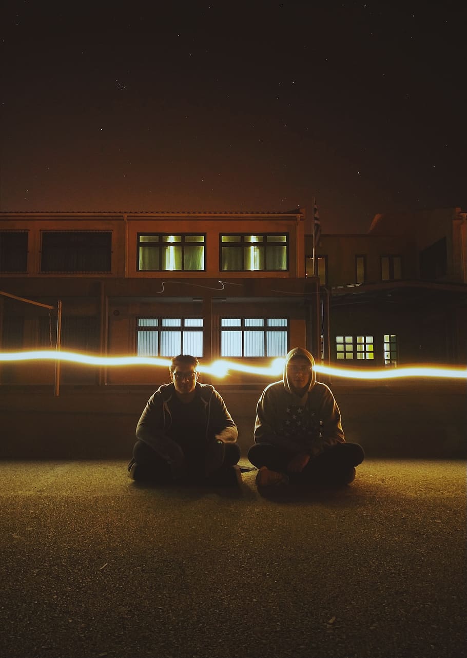 Two Man Sitting on Field, evening, landscape, light, light beam HD wallpaper