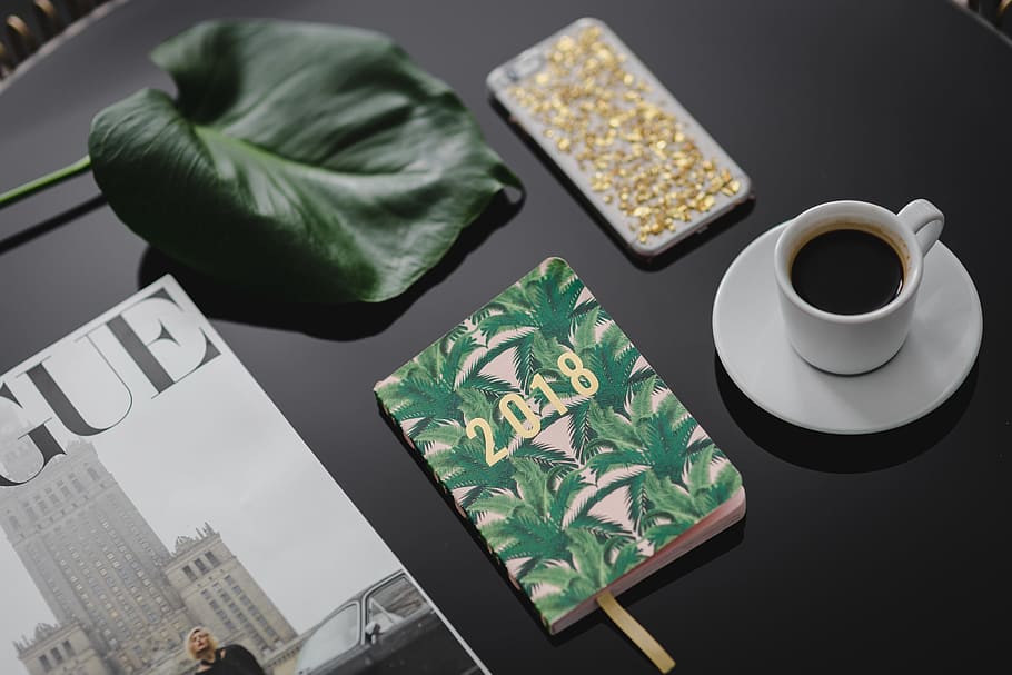 Top view of black table with 2018 calendar agenda, cup, food and drink HD wallpaper