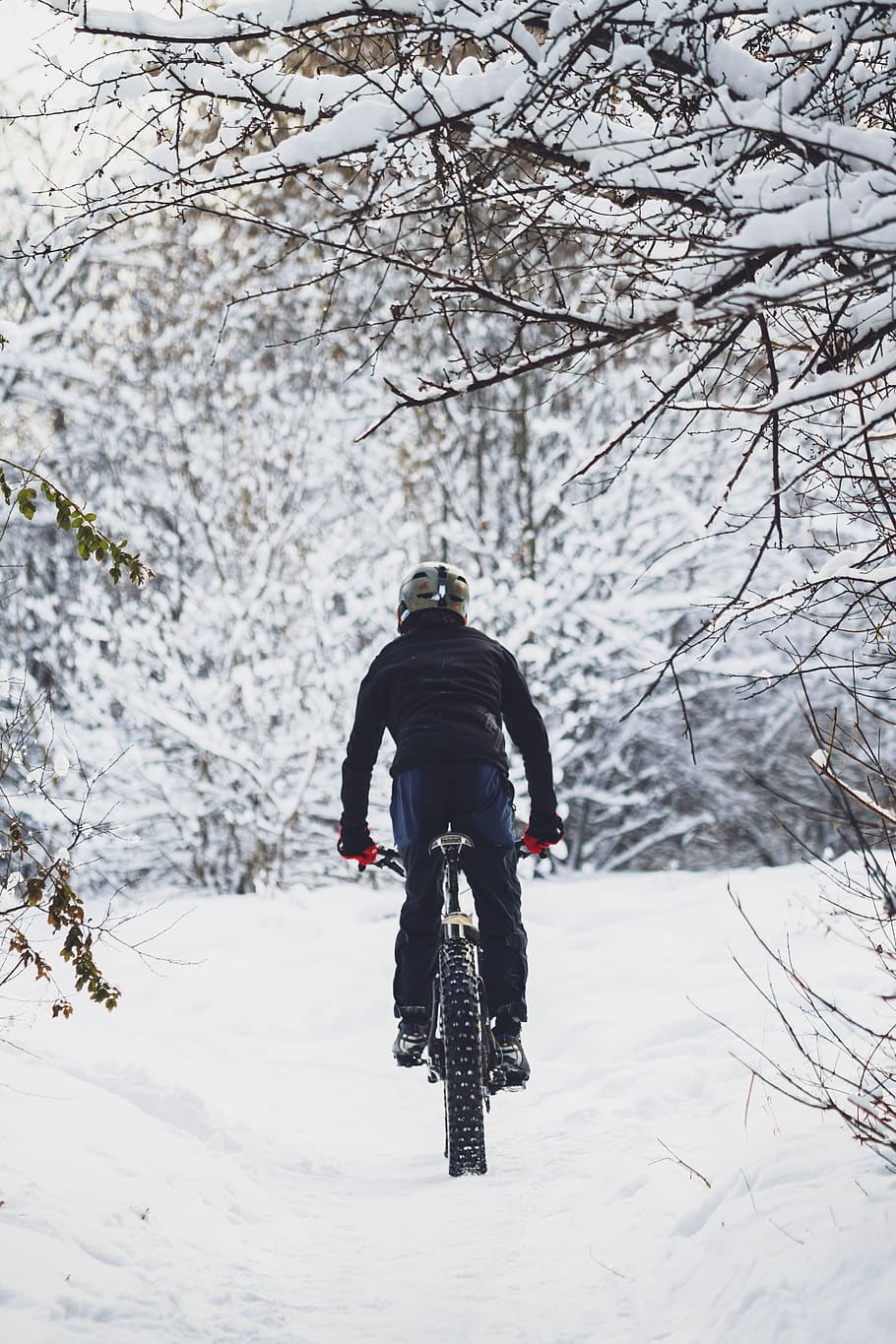 man riding bicycle on snow, person, human, bike, outdoors, transportation