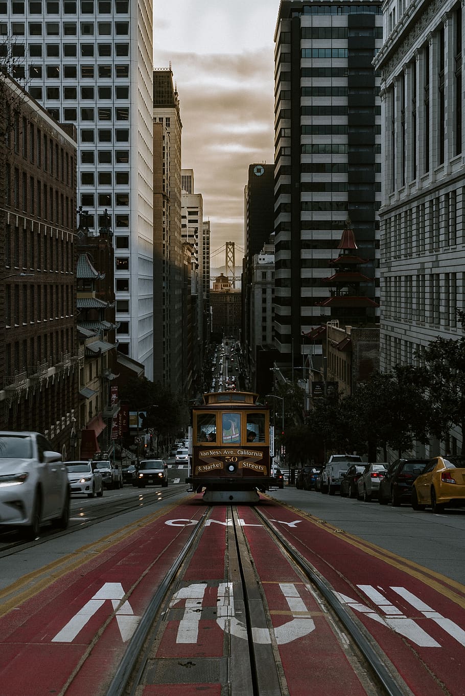 yellow train on pavement road, building exterior, city, transportation HD wallpaper
