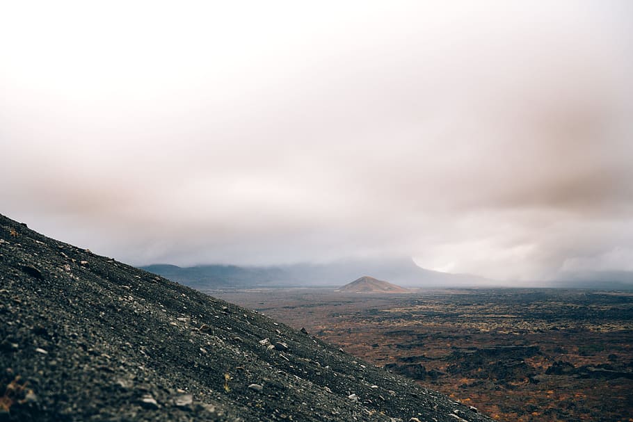 Crumbling volcanic hillside on a cloudy day, Desert, Eruption HD wallpaper