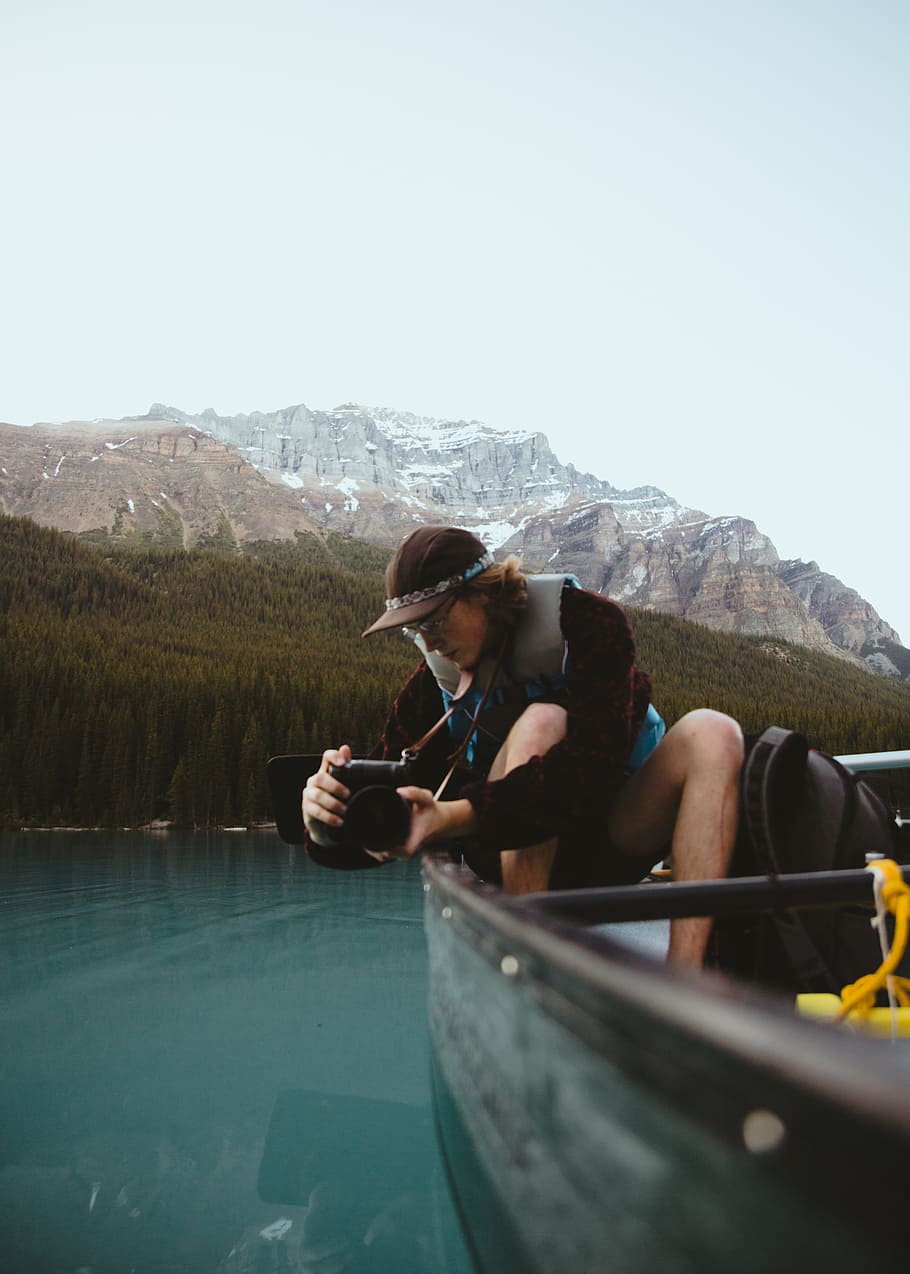 mountain, canoe, water, lake, person, glacier, tree, camera