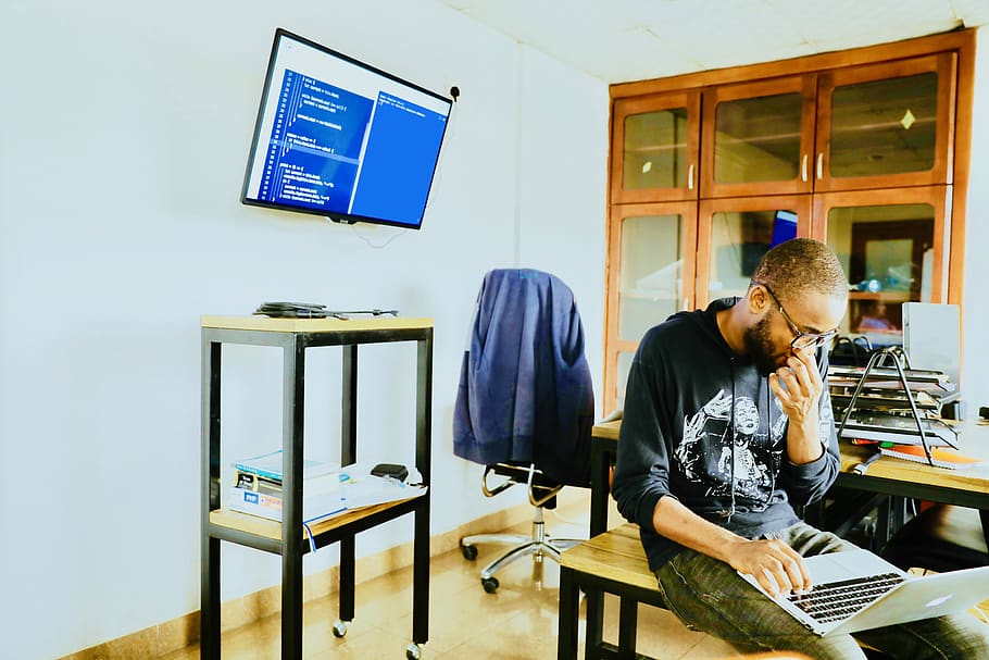 man using silver MacBook while sitting, table, real people, computer HD wallpaper