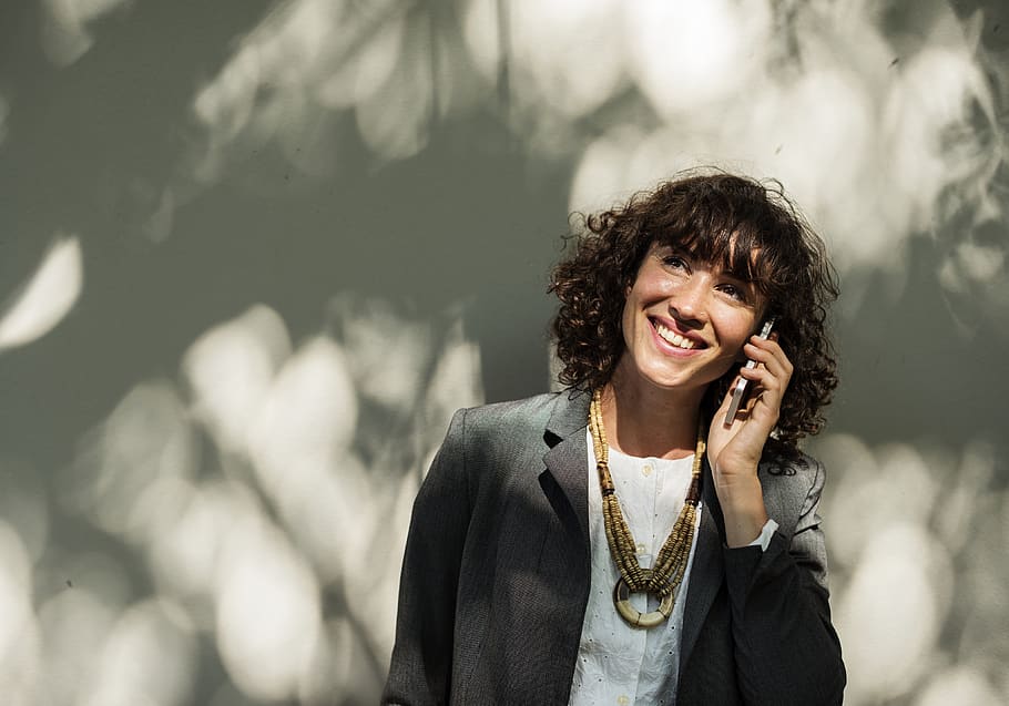 Woman Smiling While on Phone, coat, corporate, electronics, elegant HD wallpaper