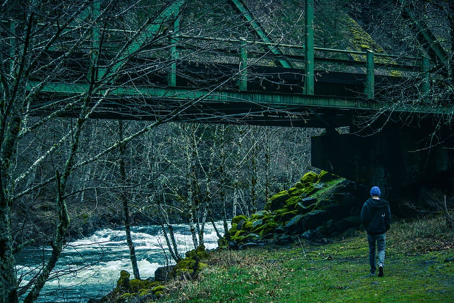 Man Walking Under Bridge Beside River, dark, daylight, environment HD wallpaper
