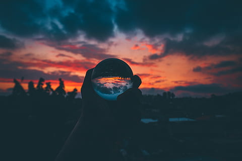 Silhouette of Person Holding Clear Ball, backlit, clouds, crystal ball HD wallpaper