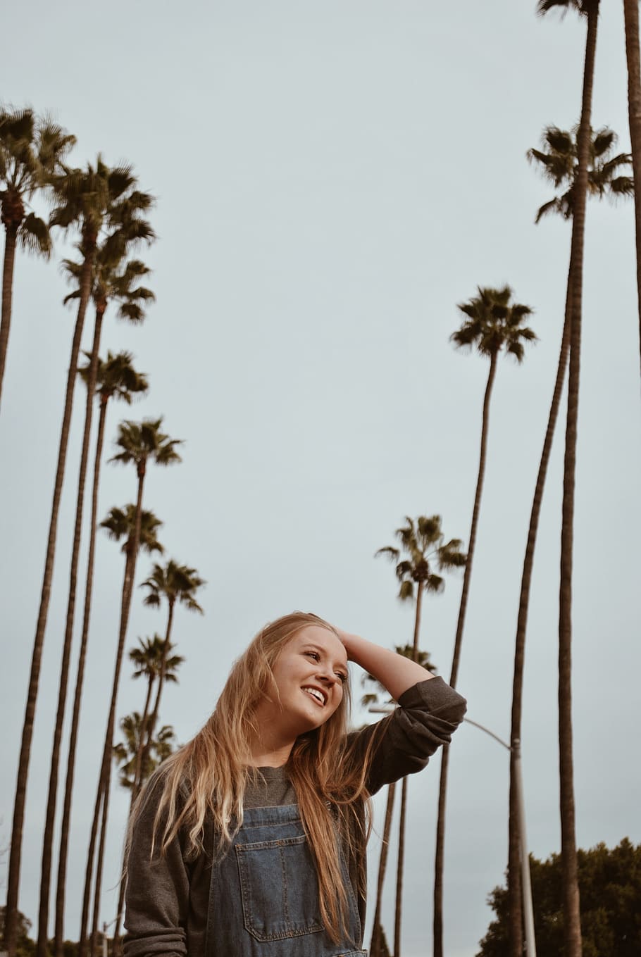 woman between coconut trees, one person, sky, happiness, leisure activity HD wallpaper