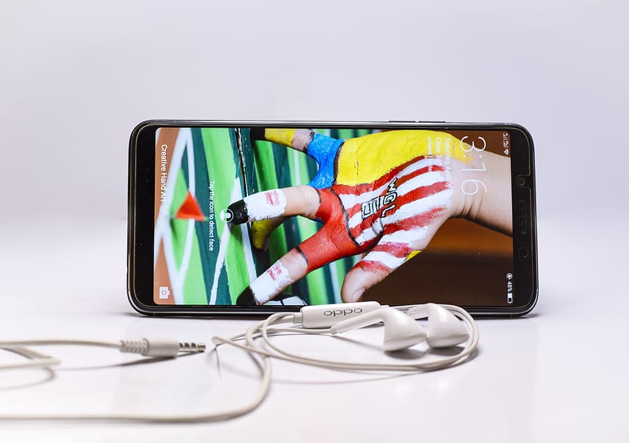 Black Android Smartphone Beside White Earphones, communication HD wallpaper
