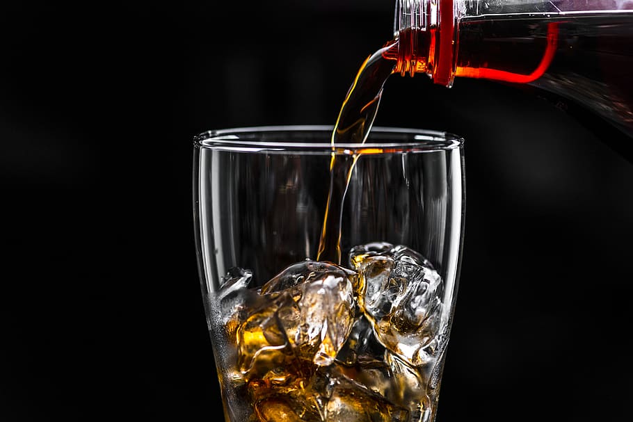 Brown Liquid Pouring on Ice Drinking Glass, alcohol, black background, HD wallpaper