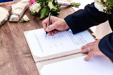 Wedding ceremony. Wedding couple leaving their signatures, hand HD wallpaper