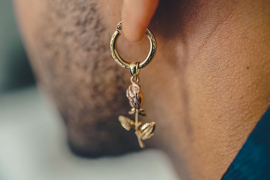 man wearing gold-colored drop earrings, accessory, accessories