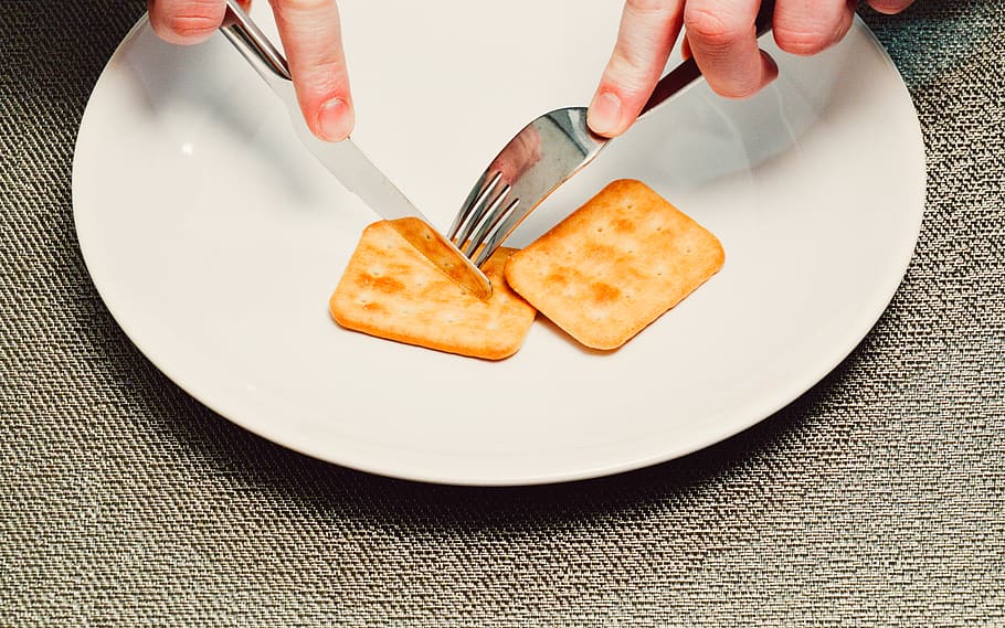 Person Slicing Biscuit Using Stainless Steel Butter Knife, biscuits