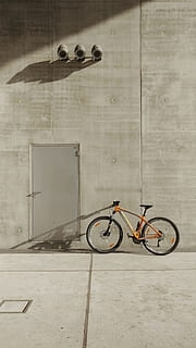 orange mountain bike beside wall, ombre, shadow, colour, color HD wallpaper