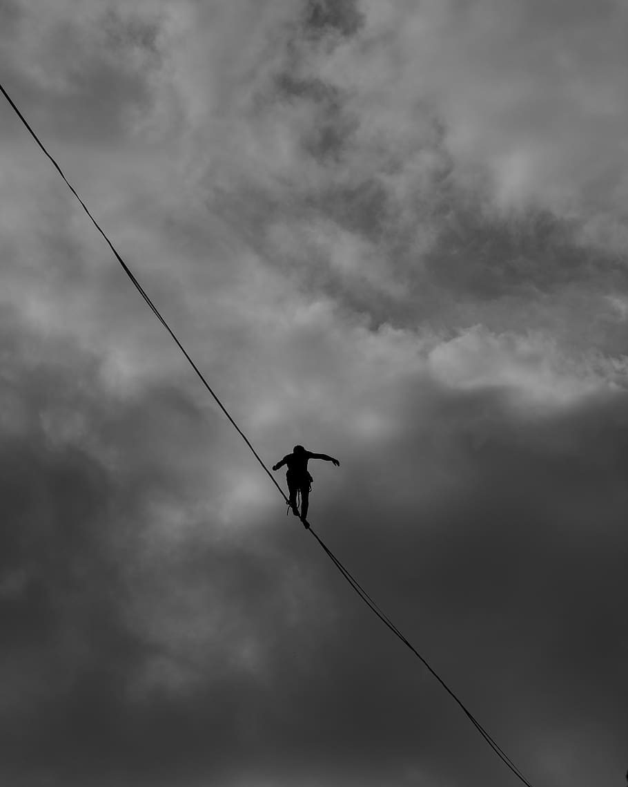 Low Angle Photo Grayscale of Person Tightrope Walking, action