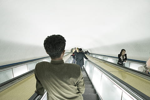 man riding escalator, person, human, metro, north korea, pyongyang HD wallpaper