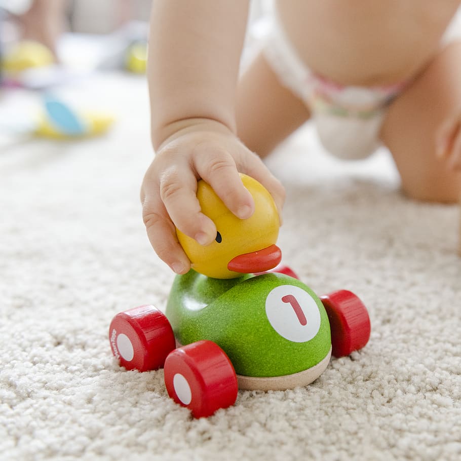 Toddler Playing Duck Toy, baby, child, hand, nursery, toy car, HD wallpaper