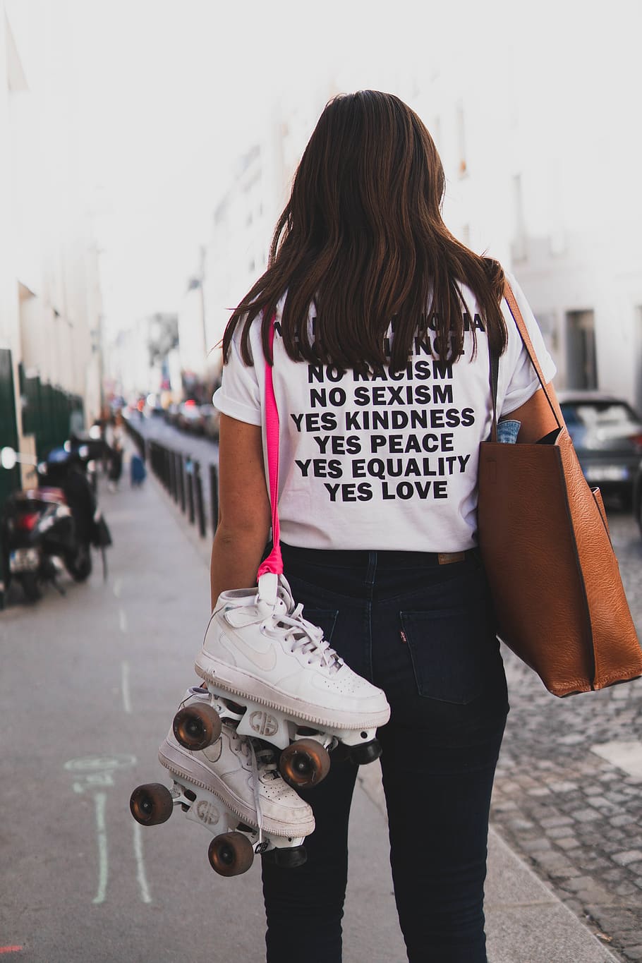 Woman in White Shirt and Denim Jeans Carries Skate Shoes and Tote Bag HD wallpaper