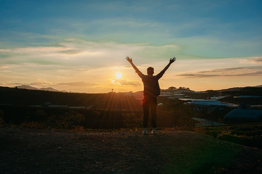 Photography of Man Raising Both Hands, backlit, clouds, dawn HD wallpaper