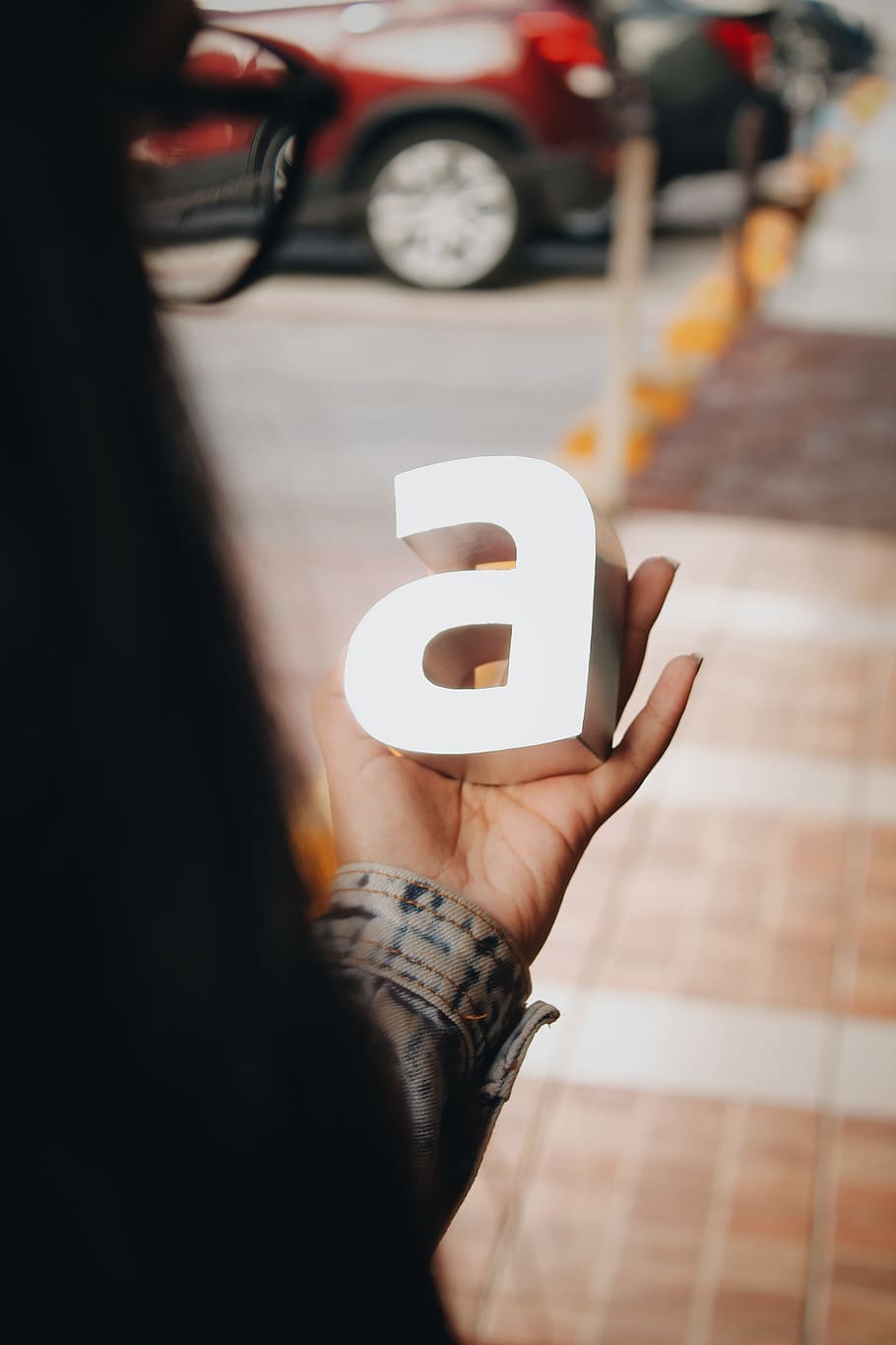 woman holding a standee, letter, hand, type, typography, street HD wallpaper