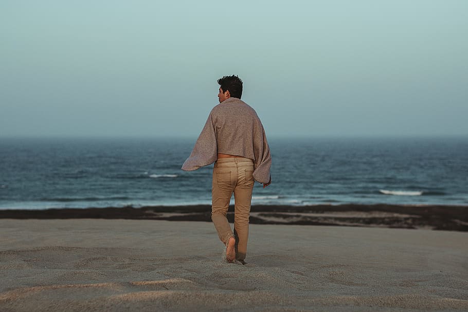 Man Walking Towards Shore With Grey Towel on Back, beach, enjoyment HD wallpaper