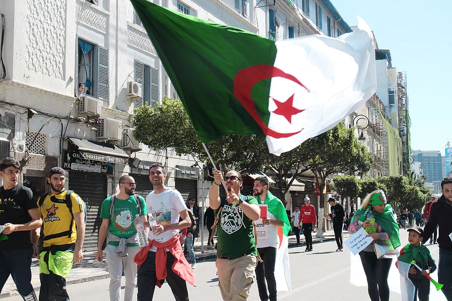 man waving flag, building exterior, architecture, city, group of people HD wallpaper