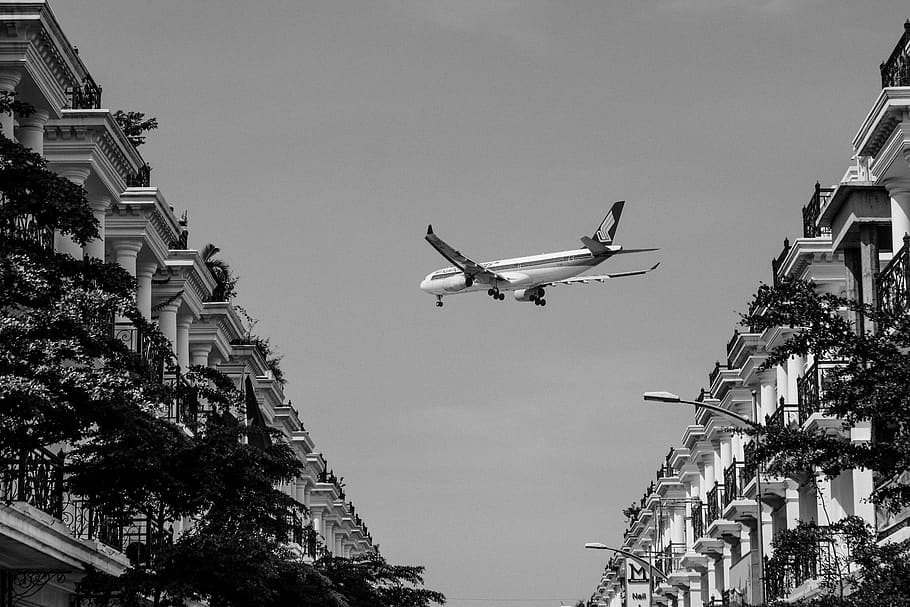gray plane above buildings, transportation, aircraft, vehicle HD wallpaper