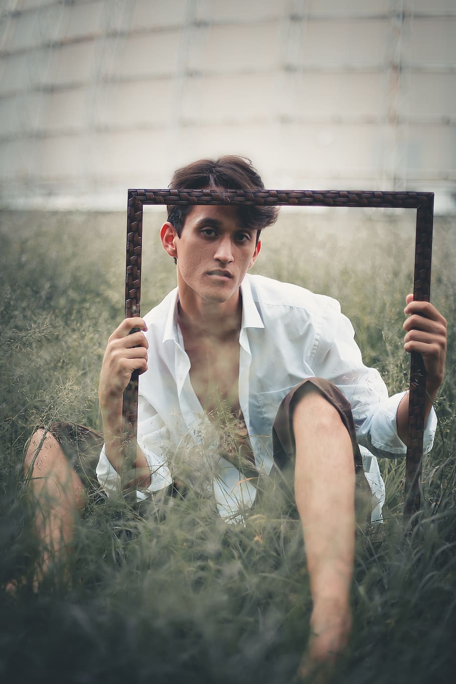 Man Lying on Green Grass Field While Folding Photo Frame, barefoot HD wallpaper