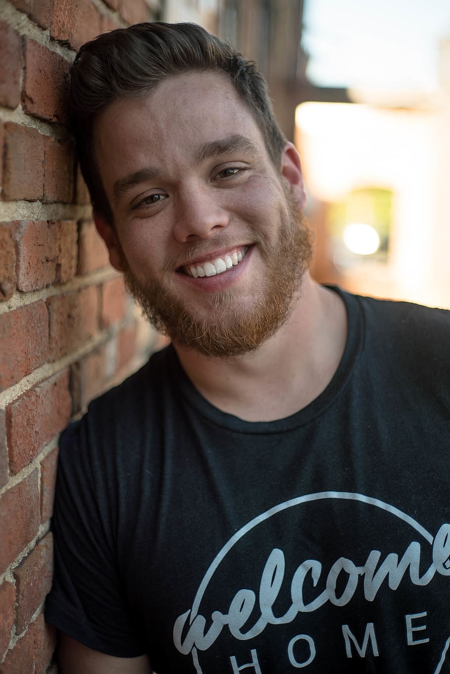 smiling man leaning on wall, portrait, one person, looking at camera HD wallpaper