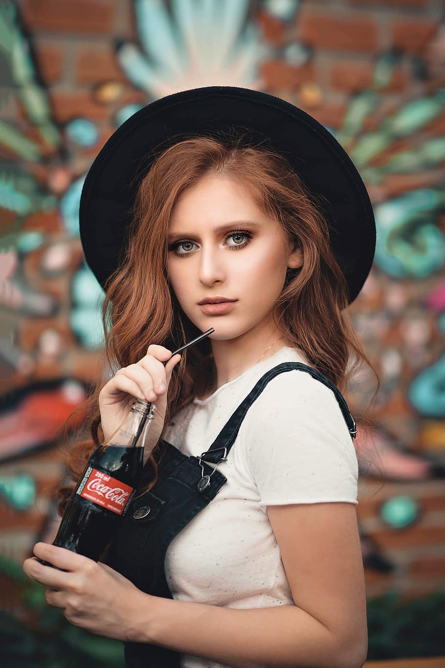 Woman in Black Hat and White Shirt Holding Coca-cola Bottle, adolescent