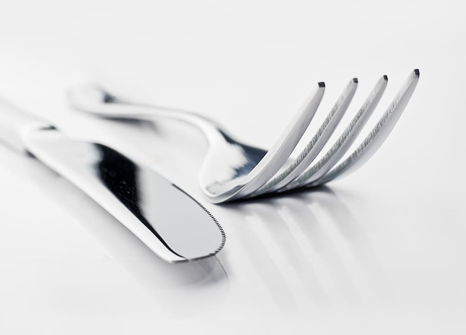 two silver bread knife and fork, white background, studio shot HD wallpaper