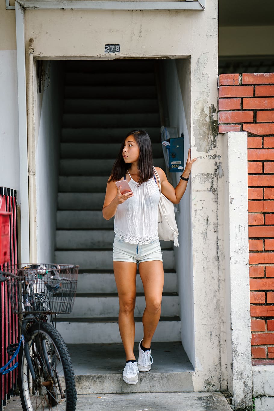 Woman Wearing White Top Holding Smartphone, apartment, bicycle HD wallpaper